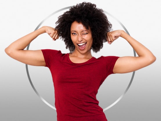 Smiling young woman with dark hair wearing red T-shirt flexing